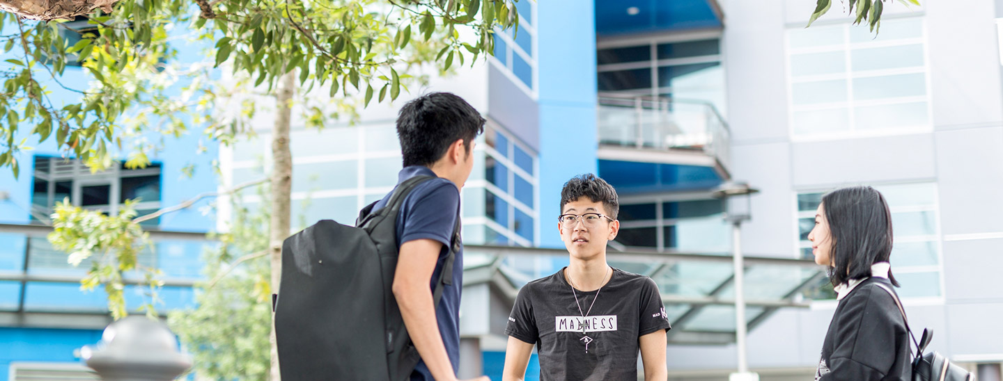 Students outside standing talking