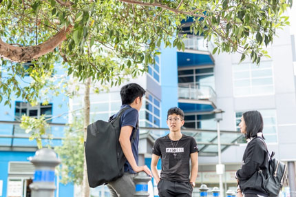 Students outside standing talking