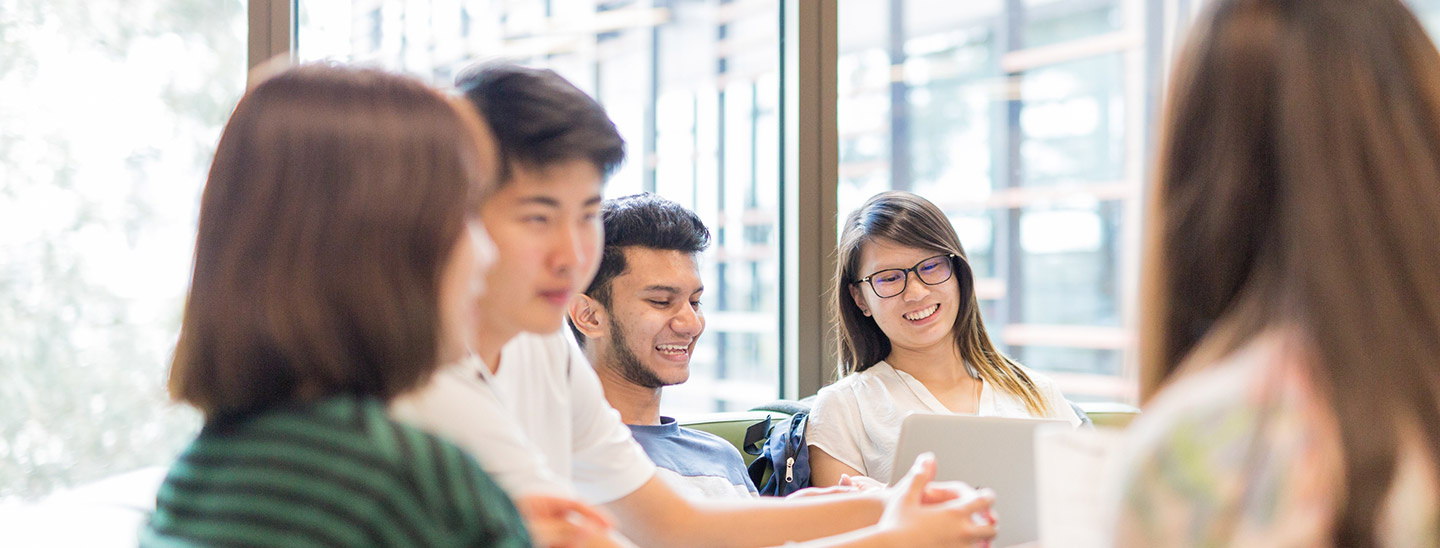 Students sitting around table working studying