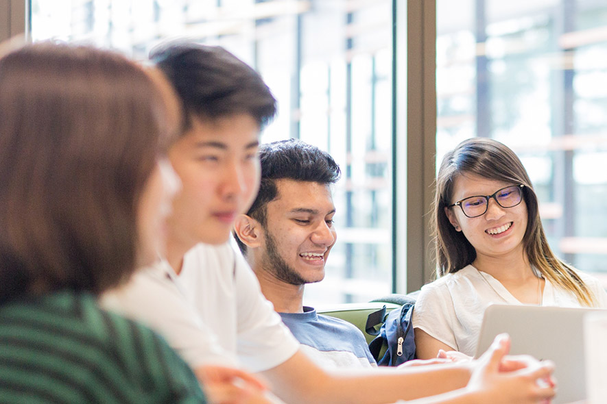 Students sitting around table working studying