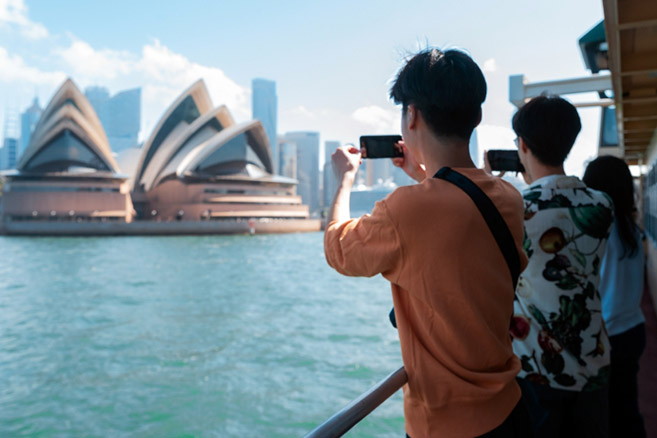 Students taking photos opera house