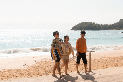 Students walking along beach