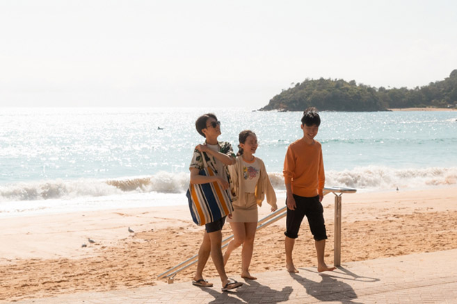 Students walking along beach