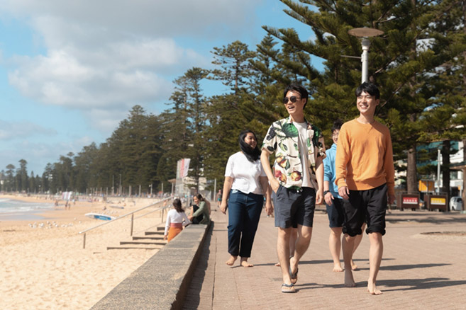 Students walking along beach