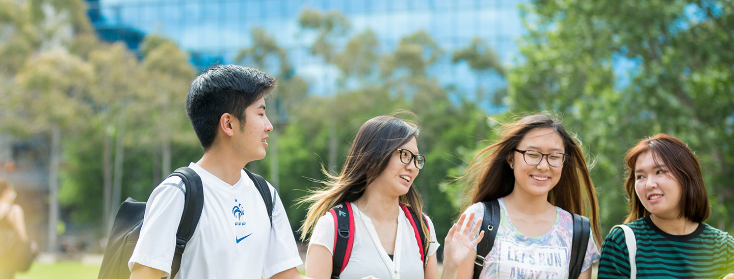 Students walking outside campus happy